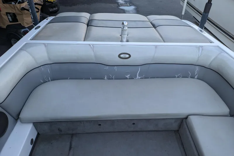 Slide: The Image of 2005 Supra Launch 21 V boat interior with gray seating and upholstery. - 12