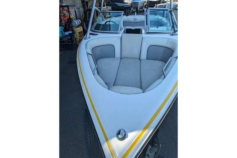 Slide: The Image of 2005 Supra Launch 21 V boat with white and gray seating in a storage area. - 14
