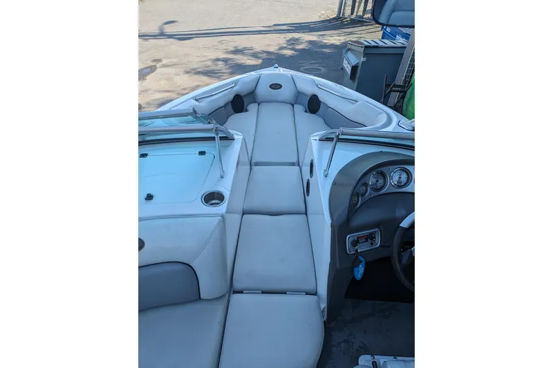 Slide: The Image of 2005 Supra Launch 21 V boat interior with white seating and dashboard view. - 20