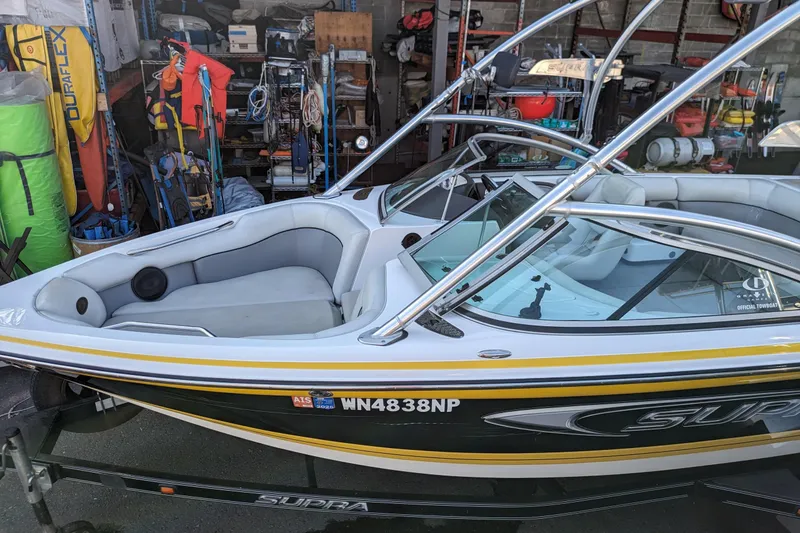 Slide: The Image of 2005 Supra Launch 21 V boat in storage, surrounded by equipment and gear. - 22