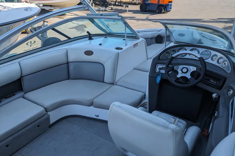 Slide: The Image of 2005 Supra Launch 21 V boat interior with steering wheel and seating area. - 23