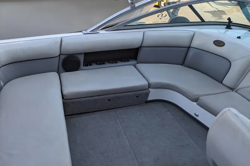 Slide: The Image of 2005 Supra Launch 21 V boat interior with gray seating and cup holders. - 24