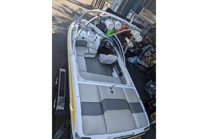 Slide: The Image of 2005 Supra Launch 21 V boat interior with gray seating and wakeboard tower. - 8