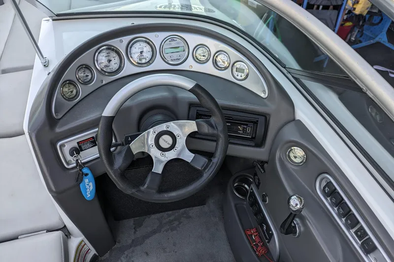 Slide: The Image of 2005 Supra Launch 21 V boat dashboard with steering wheel and instrument panel. - 9