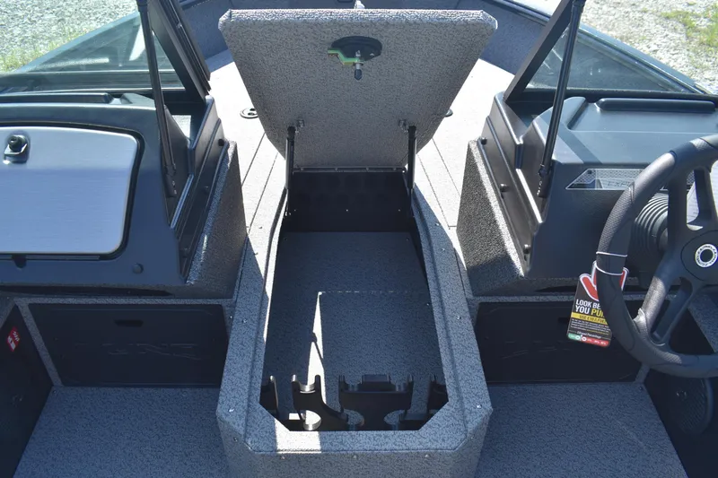 Slide: The Image of 2026 Lund 1800 Explorer Sport boat interior with open storage compartment. - 11