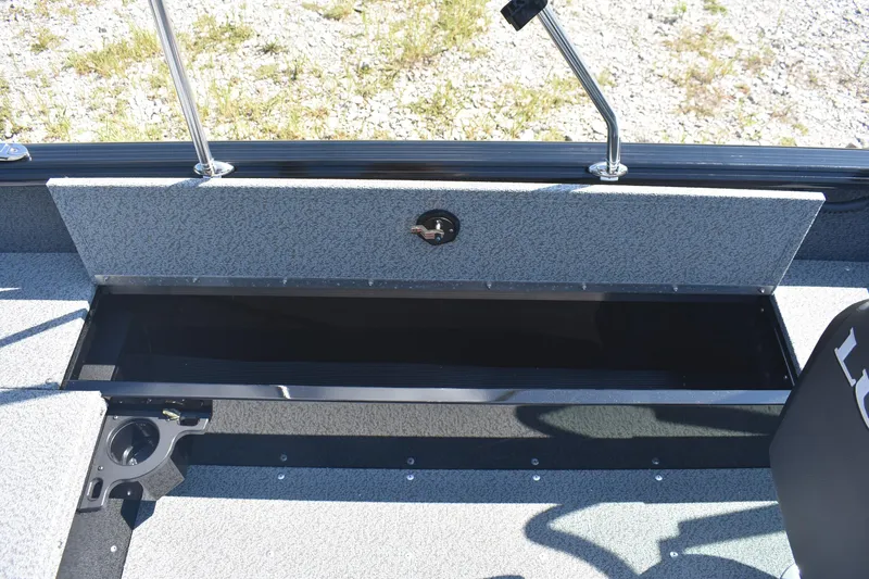 Slide: The Image of 2026 Lund 1800 Explorer Sport boat storage compartment with open lid, showcasing interior space. - 12
