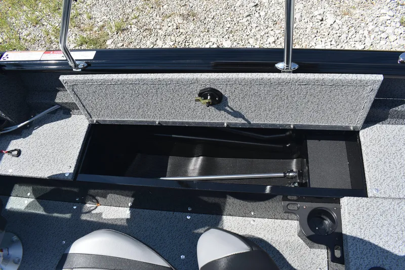 Slide: The Image of 2026 Lund 1800 Explorer Sport boat interior storage compartment with open lid. - 13