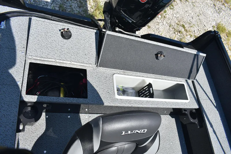 Slide: The Image of 2026 Lund 1800 Explorer Sport boat interior with storage compartments and seating. - 17