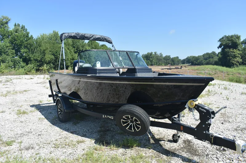 Slide: The Image of 2026 Lund 1800 Explorer Sport boat on trailer in outdoor setting. - 3