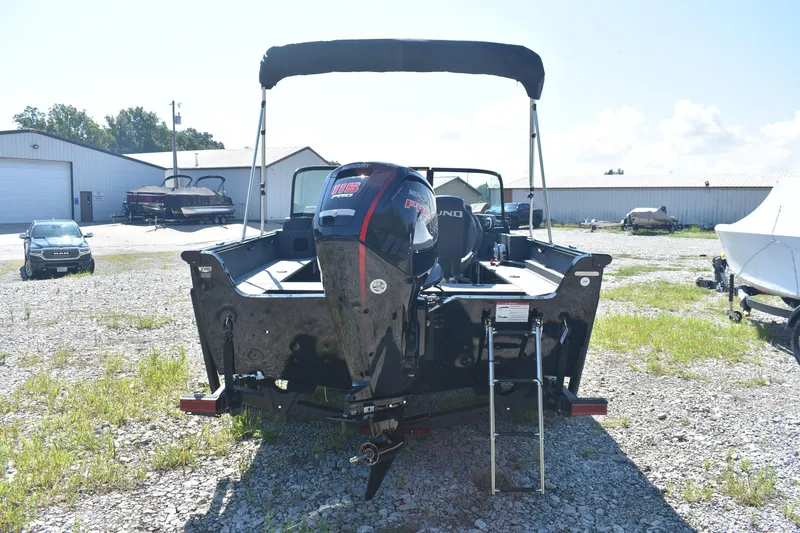 Slide: The Image of 2026 Lund 1800 Explorer Sport boat with Mercury engine, parked outdoors. - 4