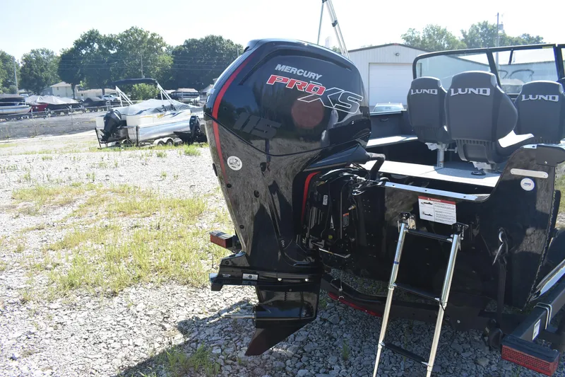 Slide: The Image of 2026 Lund 1800 Explorer Sport boat with Mercury Pro XS engine in outdoor setting. - 5