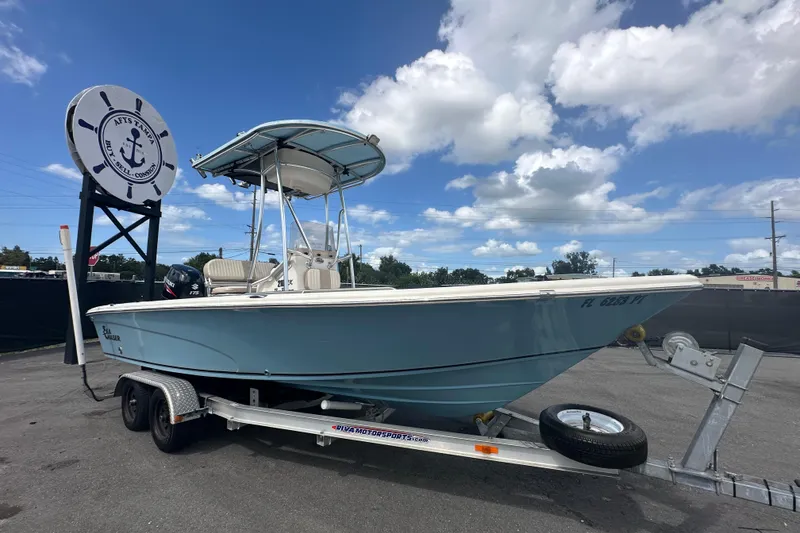 Slide: The Image of 2014 Sea Chaser 210 LX Bay Runner boat on trailer, parked outdoors. - 0