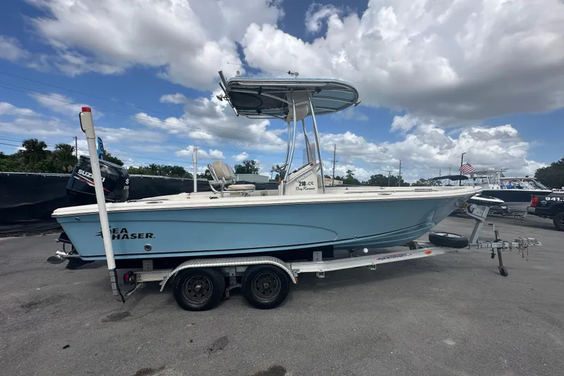Slide: The Image of 2014 Sea Chaser 210 LX Bay Runner boat on trailer, parked outdoors. - 1