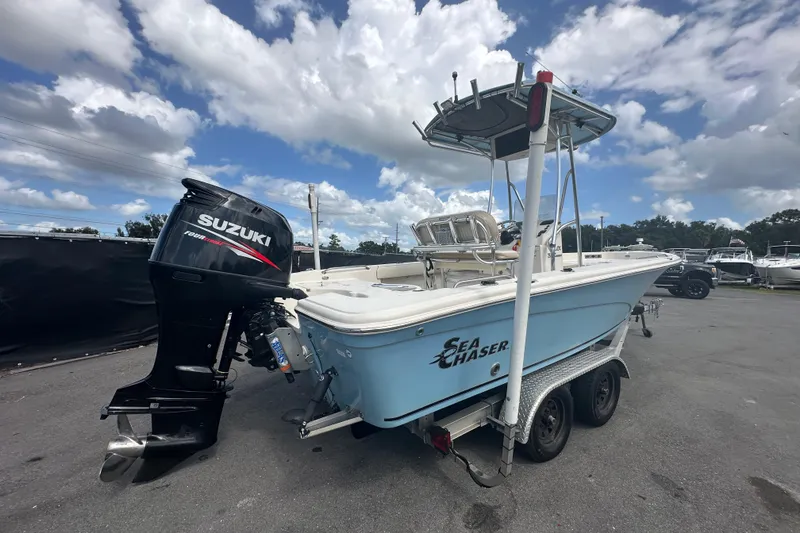 Slide: The Image of 2014 Sea Chaser 210 LX Bay Runner boat docked with blue rope. - 2