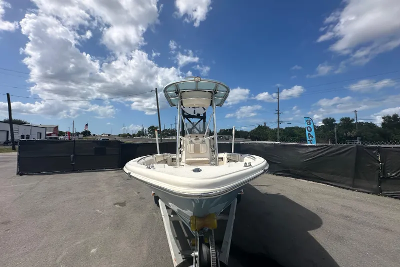 Slide: The Image of 2014 Sea Chaser 210 LX Bay Runner boat with canopy, parked outdoors. - 5