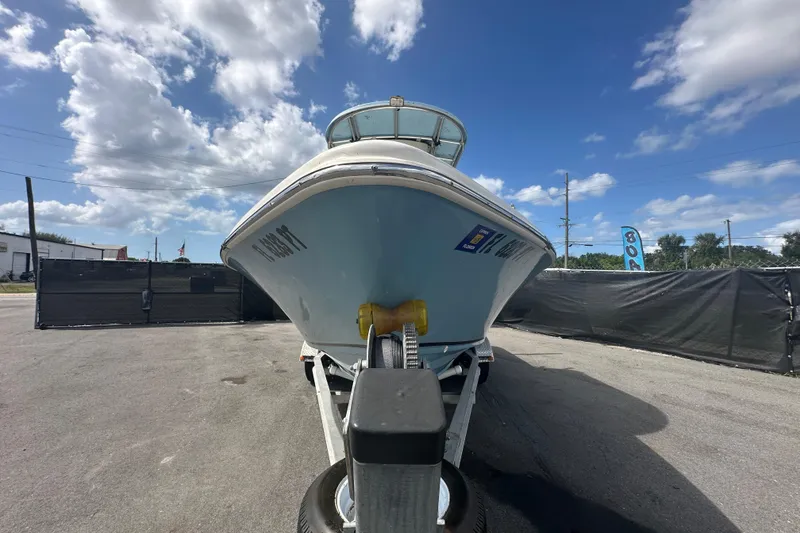 Slide: The Image of 2014 Sea Chaser 210 LX Bay Runner with Suzuki 175 outboard engine in a backyard setting. - 6