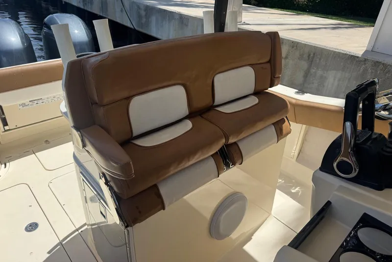 Slide: The Image of 2013 Scout 275 LXF boat interior with brown and white seating. - 30