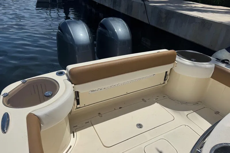 Slide: The Image of 2013 Scout 275 LXF boat with dual engines, docked by the water. - 31