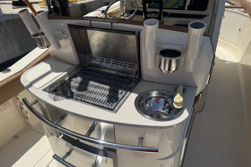 Slide: The Image of Outdoor kitchen on 2013 Scout 275 LXF boat with grill and sink. - 32