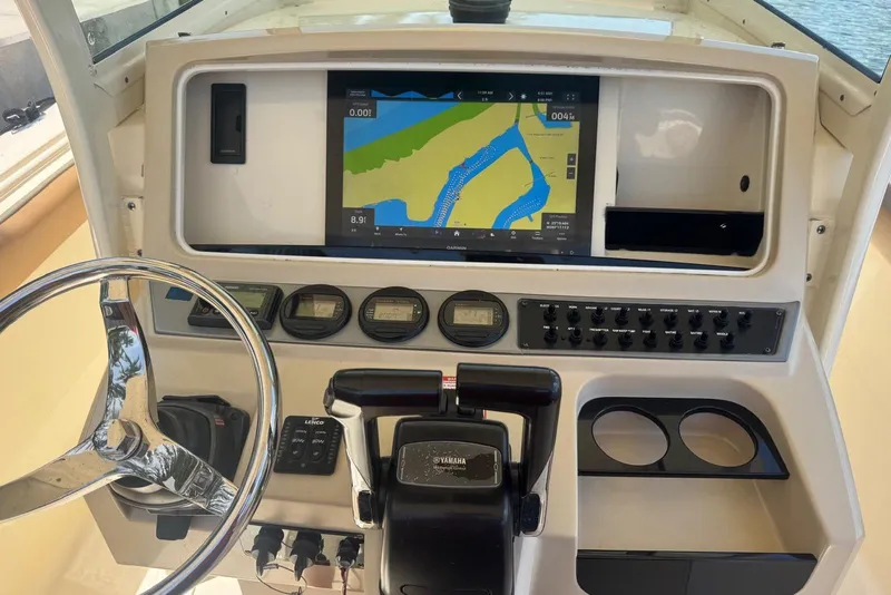 Slide: The Image of 2013 Scout 275 LXF boat dashboard with navigation screen and controls. - 33