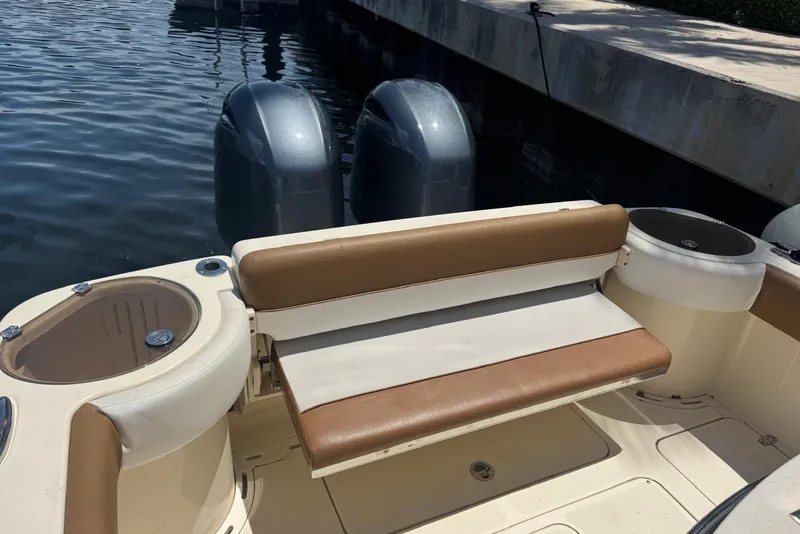 Slide: The Image of 2013 Scout 275 LXF boat with dual engines and tan seating at dock. - 34