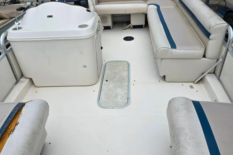 Slide: The Image of 1999 Hurricane 226R boat interior with white seating and blue accents. - 3