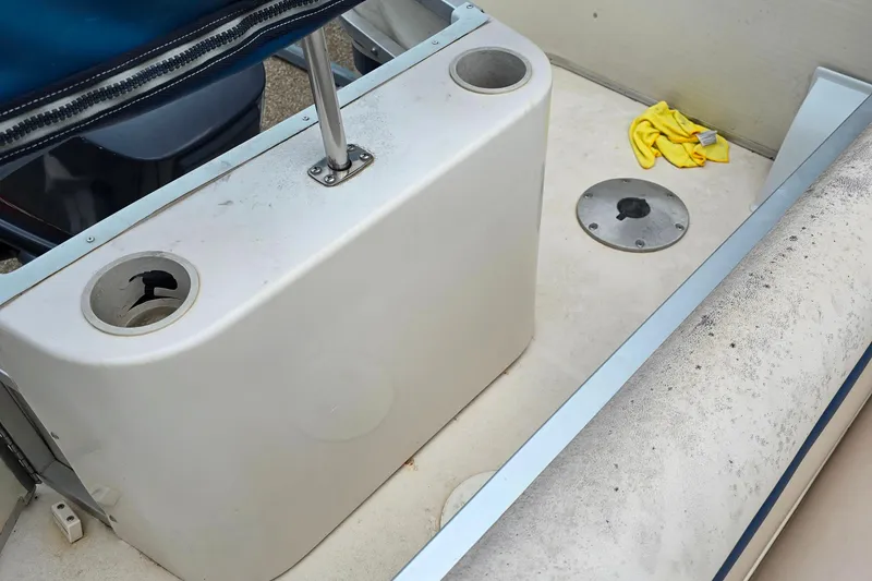 Slide: The Image of Interior of a 1999 Hurricane 226R boat with cup holders and cleaning cloth. - 7