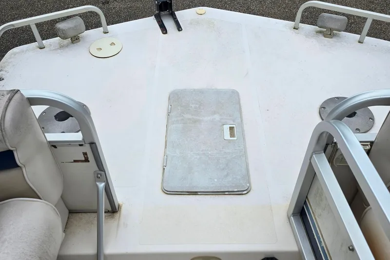 Slide: The Image of 1999 Hurricane 226R boat deck with seating and storage hatch. - 8