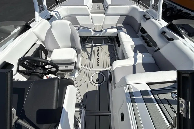 Slide: The Image of 2026 Moomba Mondo boat interior with white seating and sleek design. - 12