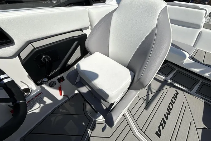 Slide: The Image of 2026 Moomba Mondo boat interior with gray and white seating and steering wheel. - 13