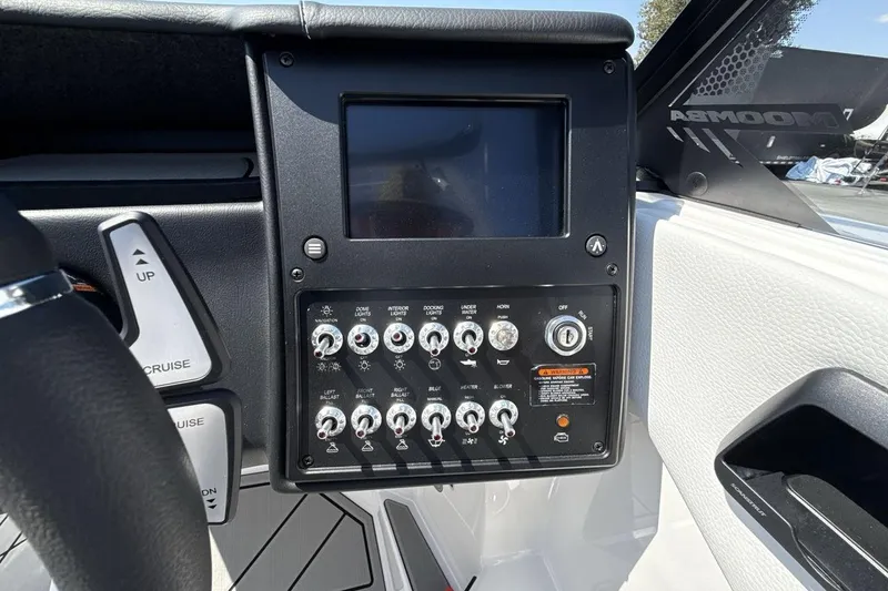 Slide: The Image of 2026 Moomba Mondo boat dashboard with control panel and touchscreen display. - 15