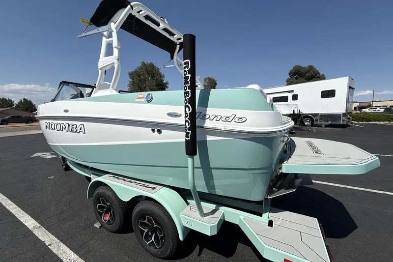 Slide: The Image of 2026 Moomba Mondo boat on trailer, parked outdoors under clear sky. - 3