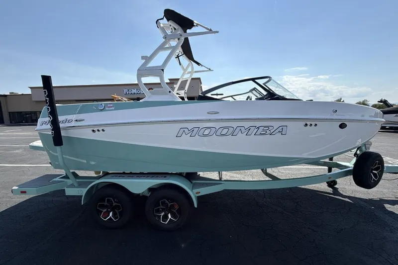 Slide: The Image of 2026 Moomba Mondo boat on trailer in parking lot, side view. - 6