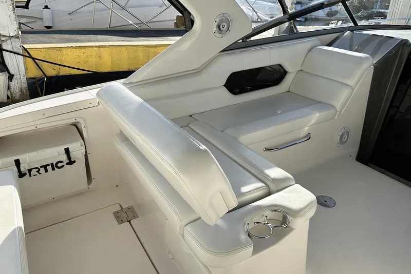 Slide: The Image of 2008 Regal 3360 Window Express boat interior with white seating and cup holders. - 10