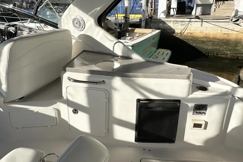 Slide: The Image of 2008 Regal 3360 Window Express boat interior with sink and seating area. - 11