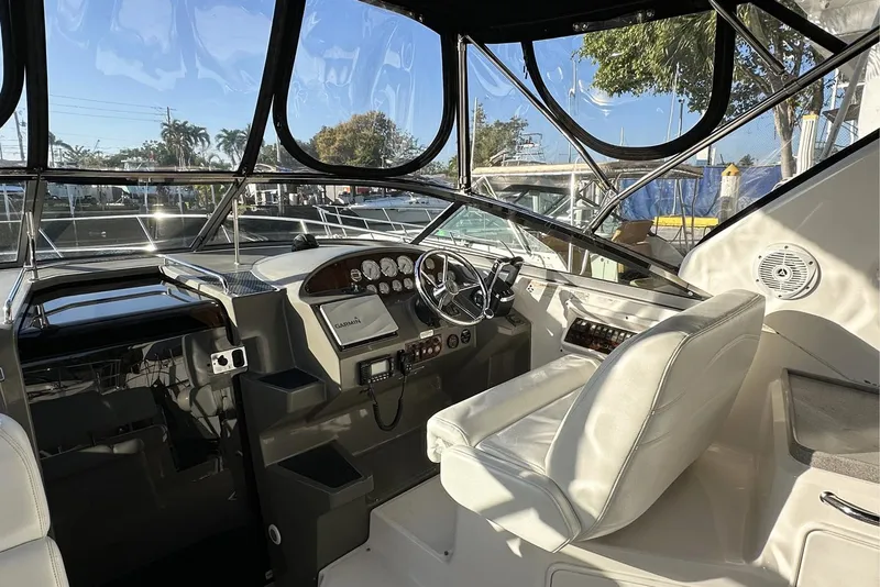 Slide: The Image of 2008 Regal 3360 Window Express boat cockpit with steering wheel and controls. - 12
