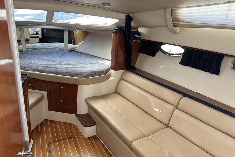 Slide: The Image of Interior of 2008 Regal 3360 Window Express yacht with beige seating and wood accents. - 17