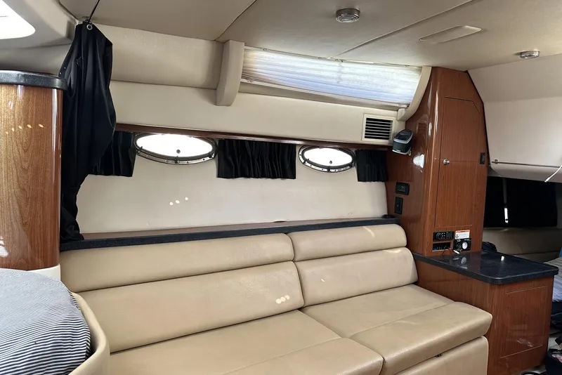 Slide: The Image of Interior of 2008 Regal 3360 Window Express yacht with beige seating and wood accents. - 21