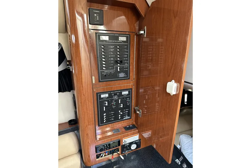 Slide: The Image of 2008 Regal 3360 Window Express electrical panel with wooden cabinet door open. - 22