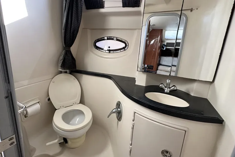 Slide: The Image of 2008 Regal 3360 Window Express bathroom with toilet, sink, and mirror. - 23