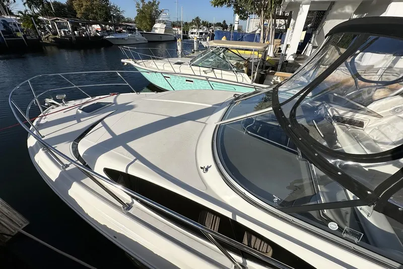 Slide: The Image of 2008 Regal 3360 Window Express boat docked at marina, sunny day, clear water. - 3