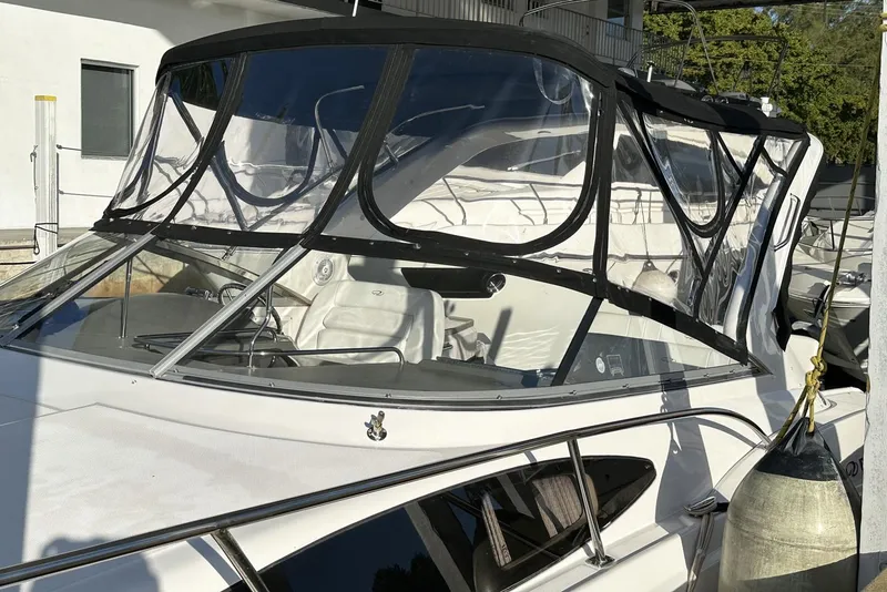 Slide: The Image of 2008 Regal 3360 Window Express boat with sleek design and protective canopy. - 5