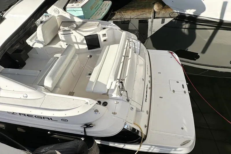 Slide: The Image of 2008 Regal 3360 Window Express boat docked, featuring spacious seating and sleek design. - 6