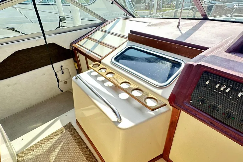 Slide: The Image of 1987 Sea Ray 340 Sundancer helm with control panel and cup holders. - 14