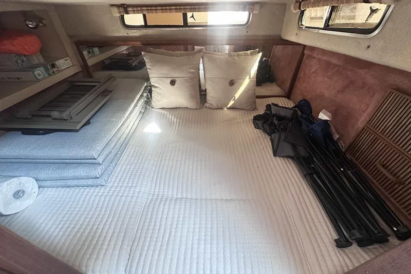 Slide: The Image of Interior cabin of 1987 Sea Ray 340 Sundancer with cushions and folded equipment. - 16