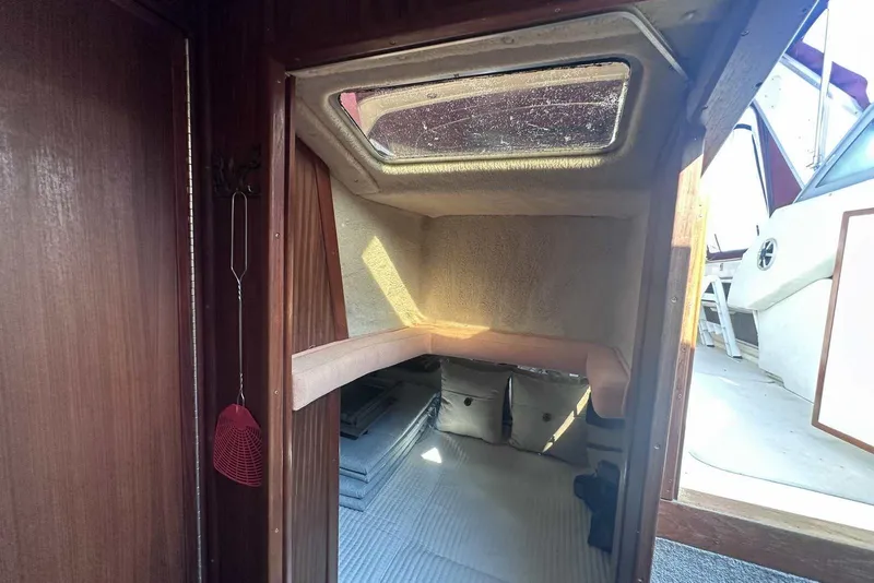 Slide: The Image of Interior cabin of 1987 Sea Ray 340 Sundancer with cozy sleeping area and skylight. - 18