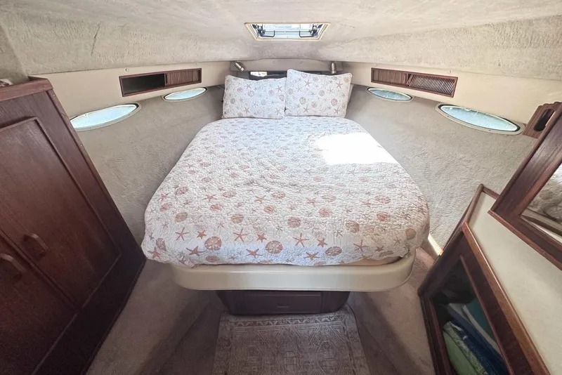 Slide: The Image of Cozy cabin interior of 1987 Sea Ray 340 Sundancer with bed and porthole windows. - 20