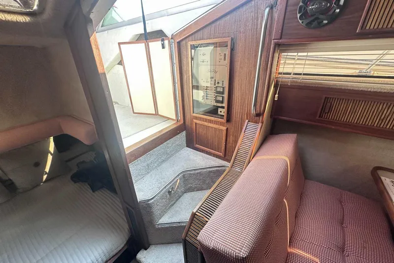 Slide: The Image of Interior of 1987 Sea Ray 340 Sundancer boat with seating and control panel. - 28