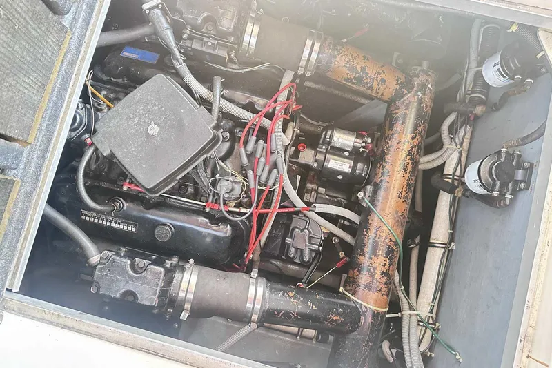 Slide: The Image of Engine compartment of a 1987 Sea Ray 340 Sundancer, showing mechanical components and wiring. - 29