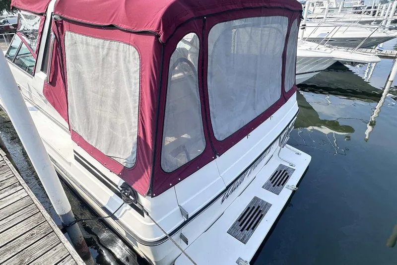 Slide: The Image of 1987 Sea Ray 340 Sundancer docked with maroon canvas cover. - 5
